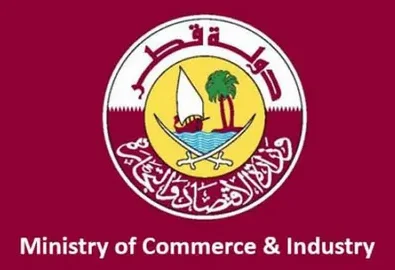 Trademark Registration in Qatar - Logo of Qatar’s Ministry of Economy and Commerce: a maroon background with a circular emblem featuring a dhow boat on water, palm trees, and crossed swords, with Arabic text above and “Ministry of Economy and Commerce” written in English below.